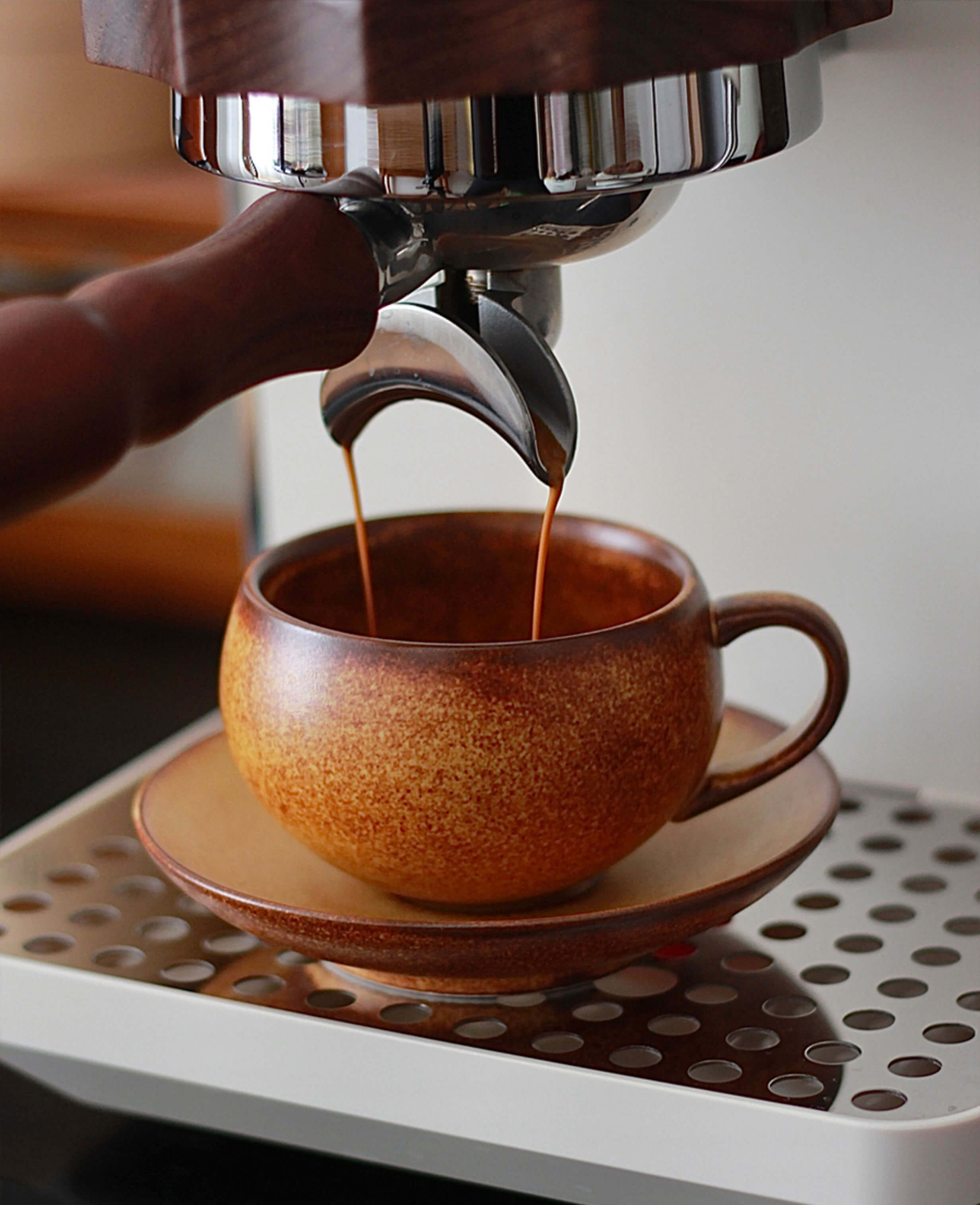 toffee reverie ovolo ceramic coffee cup under espresso machine during brewing