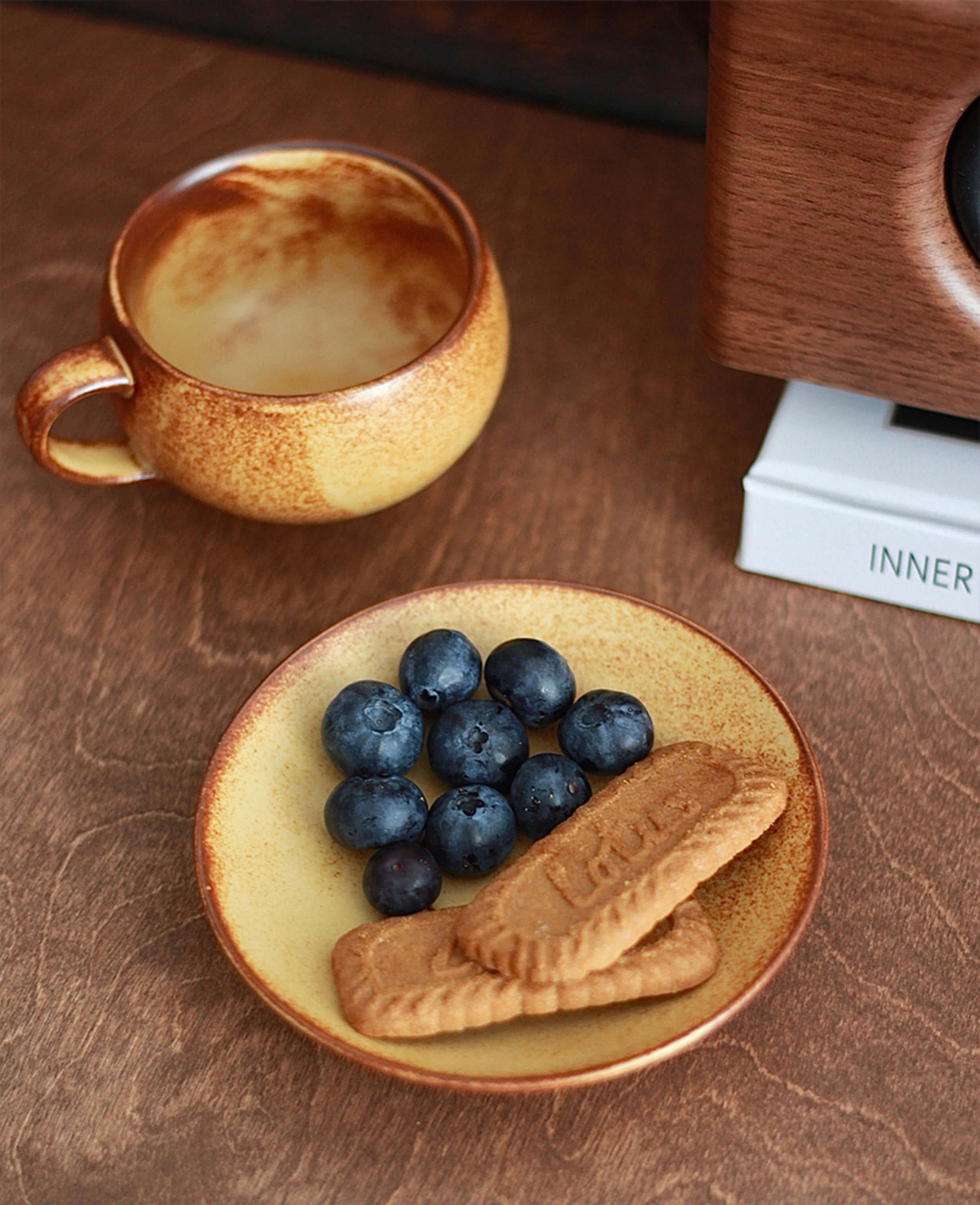 top view of toffee reverie ovolo ceramic cup and saucer showing interior glaze and rounded design