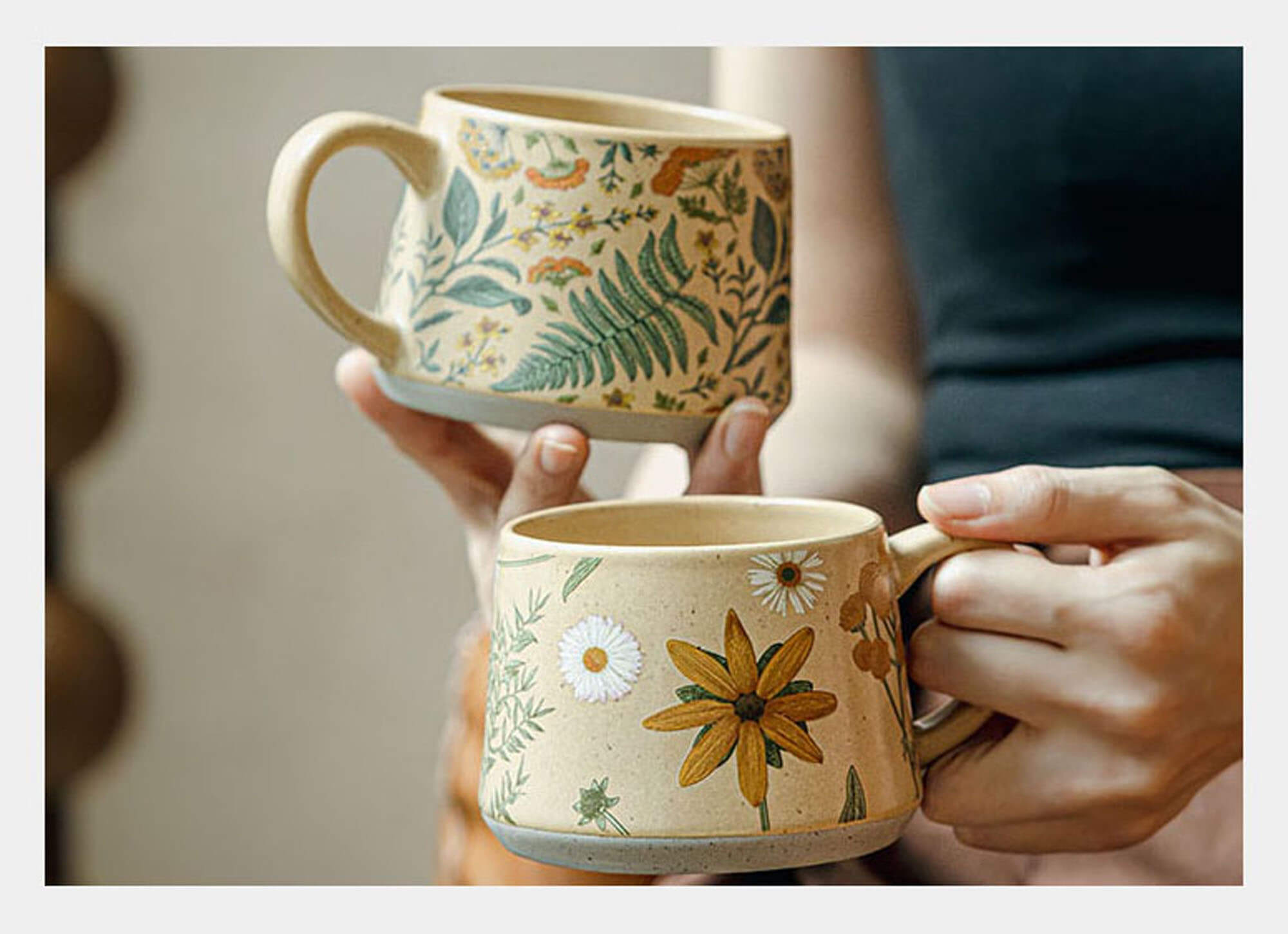 ts and cs gift card image featuring summer imprint handcrafted ceramic coffee mugs held in hands with natural day light